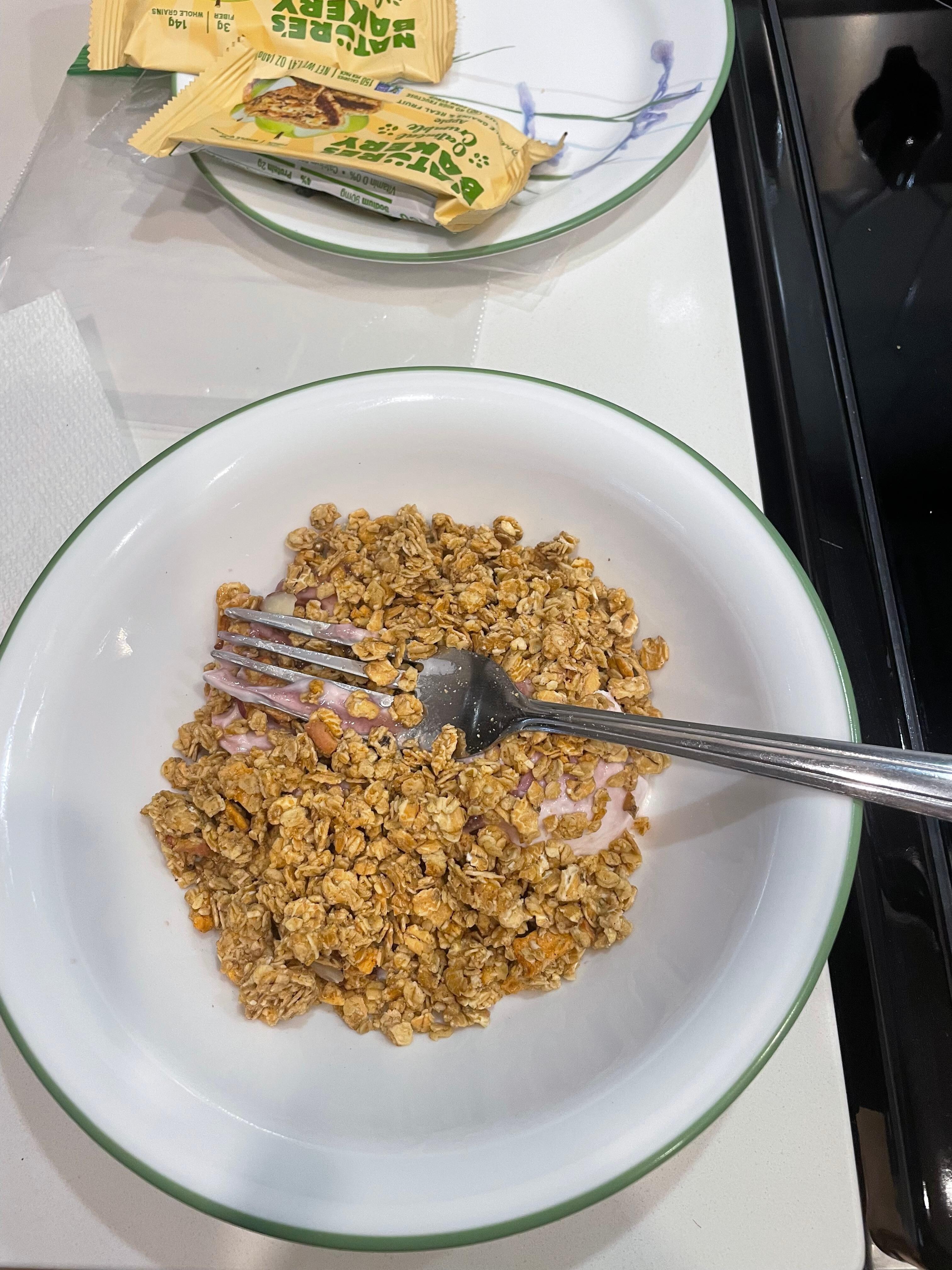 Eating yogurt and cereal with a fork because we had no spoon