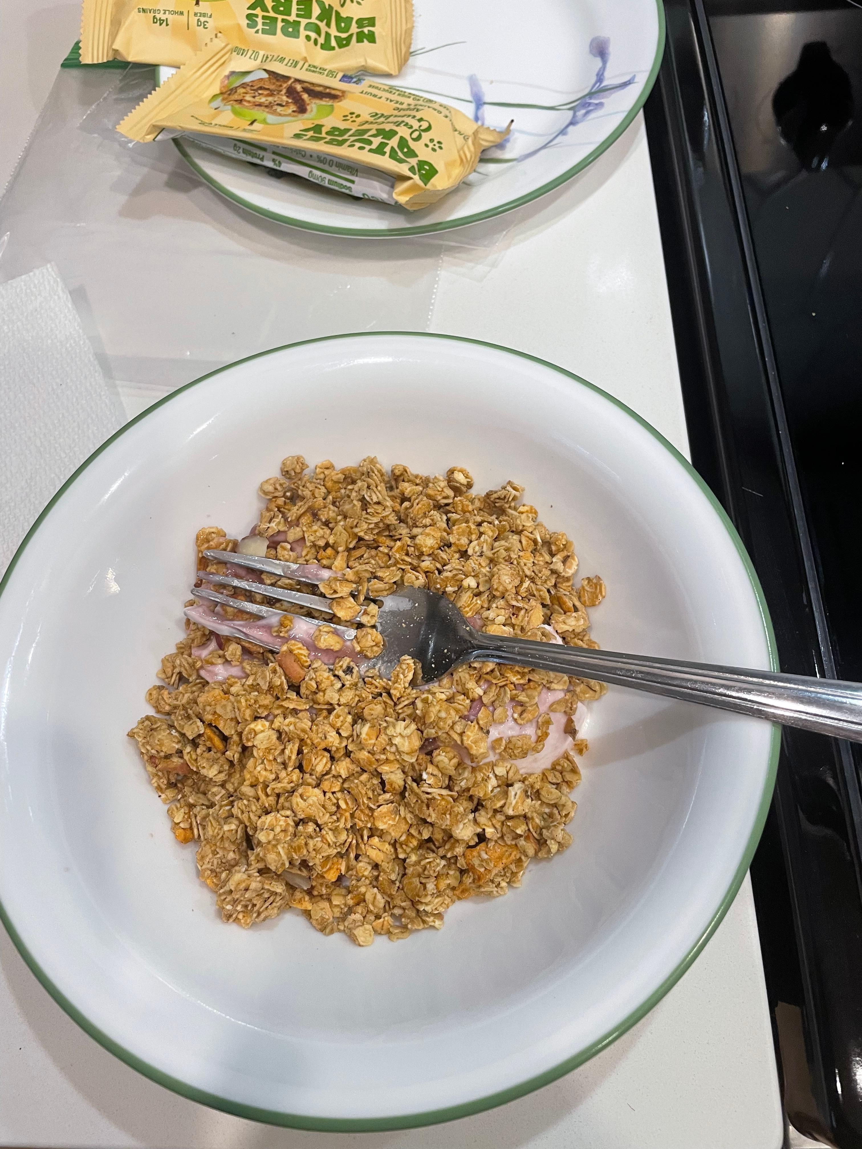Eating yogurt and cereal with a fork because we had no spoon