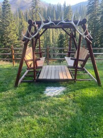 Glider on back lawn by deck