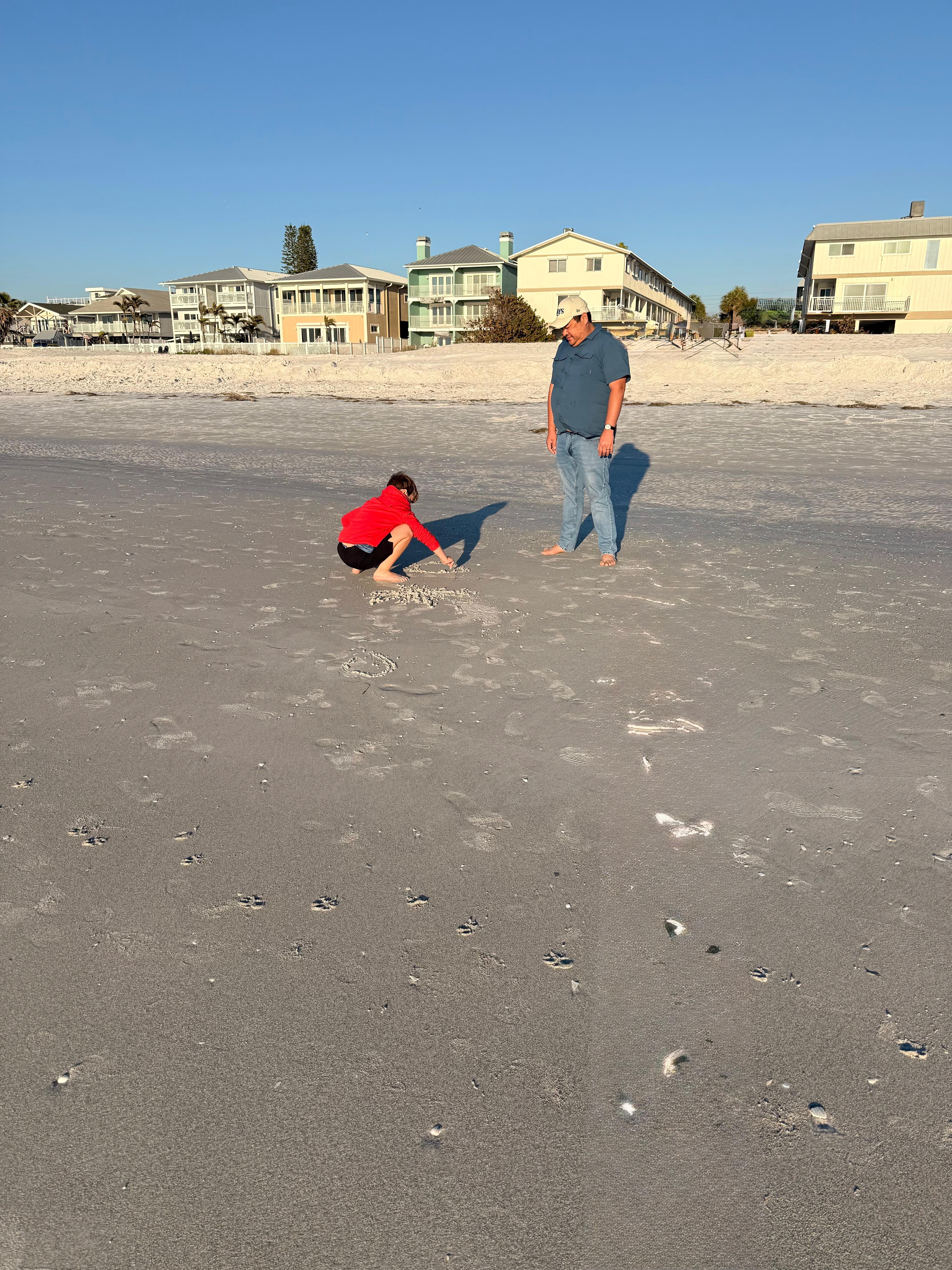 This was just before sunset on day of check-in. The buildings in the background are slender and the condo is just next to the beach really, right there beyond the public access opening. 