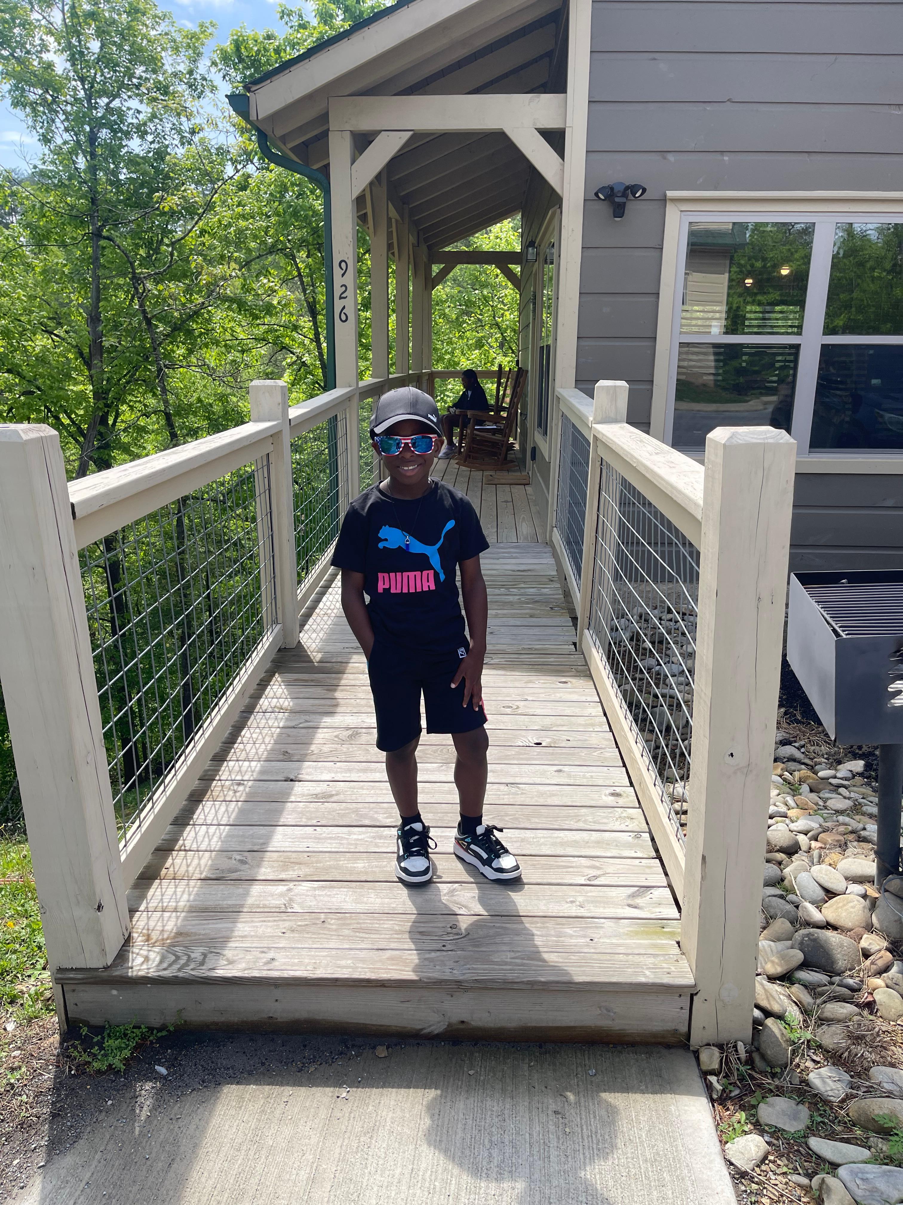 My son chilling in front of the house 