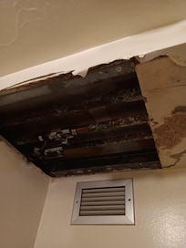 hole in ceiling and exposed pipes