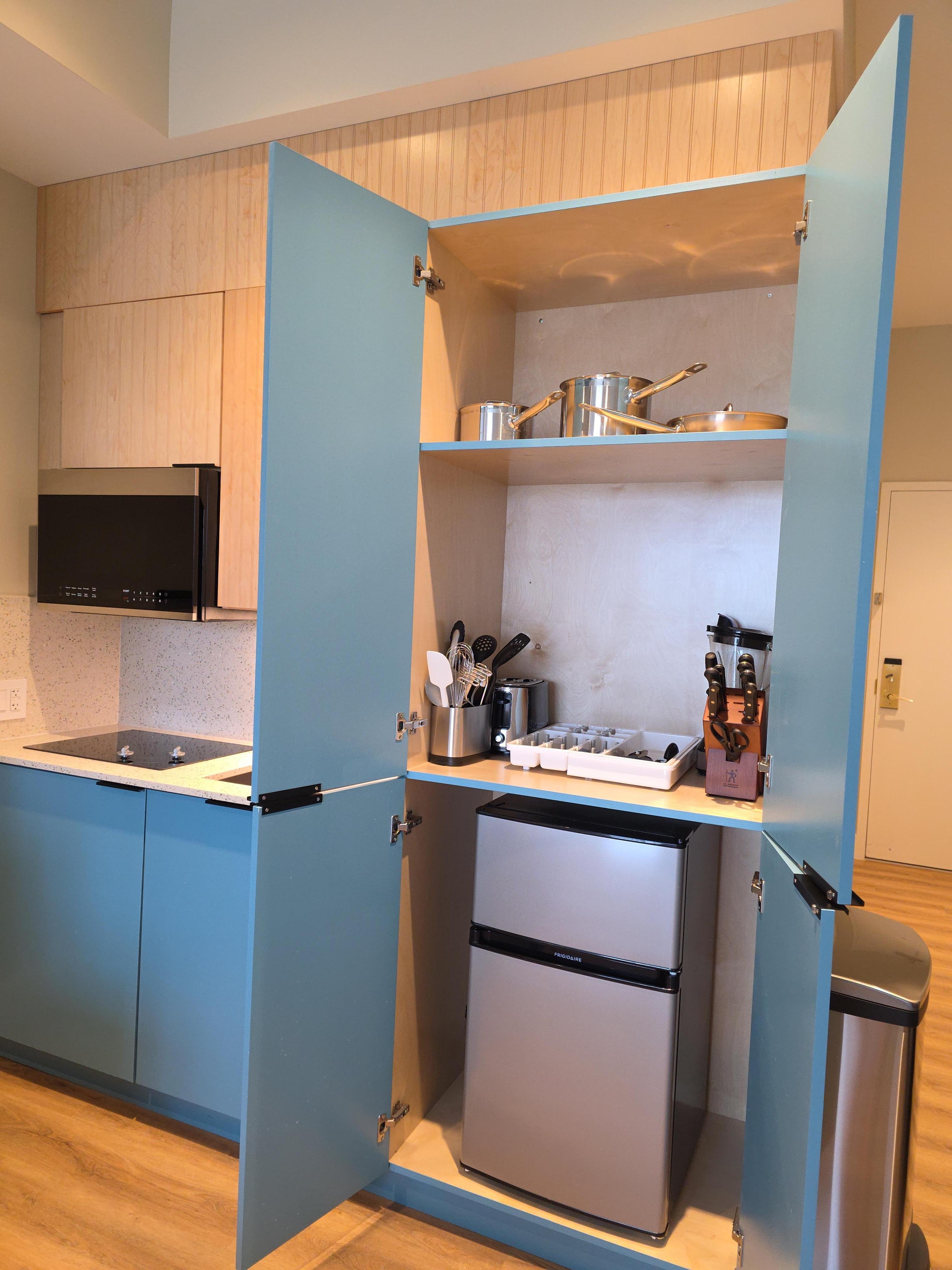 All the items needed in mini kitchen, microwave, blender, toaster, utensils, dishes and pots and pan