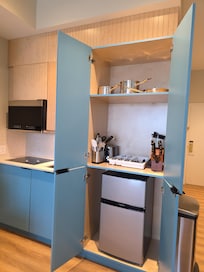 All the items needed in mini kitchen, microwave, blender, toaster, utensils, dishes and pots and pan