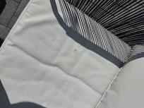 Actual rooftop cushion with cigarette burn