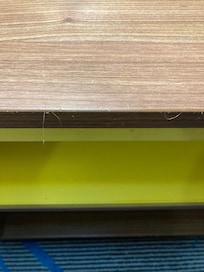 Hair stuck to the edge of the night stand
