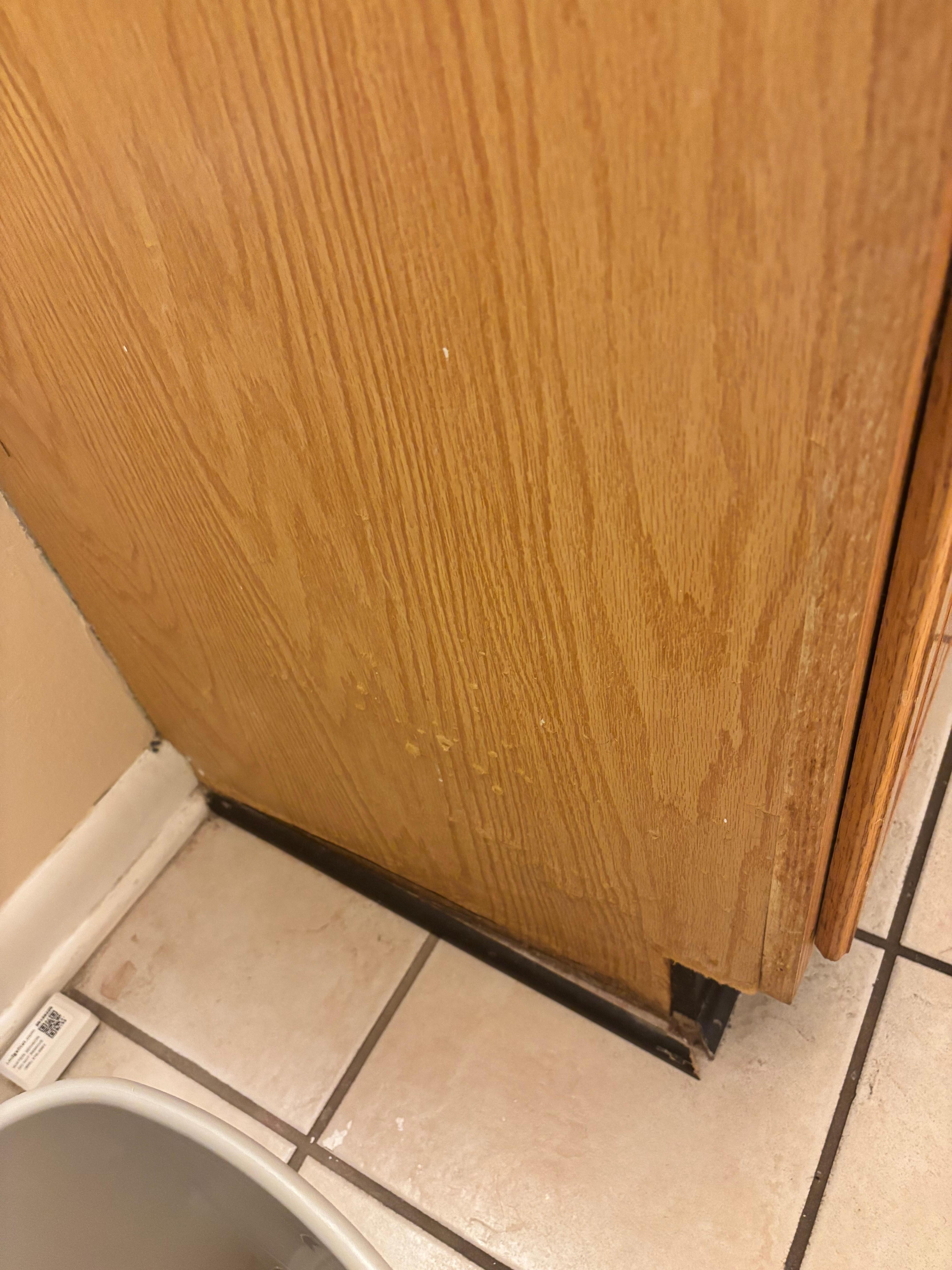 Dirty restroom cabinet with damaged border