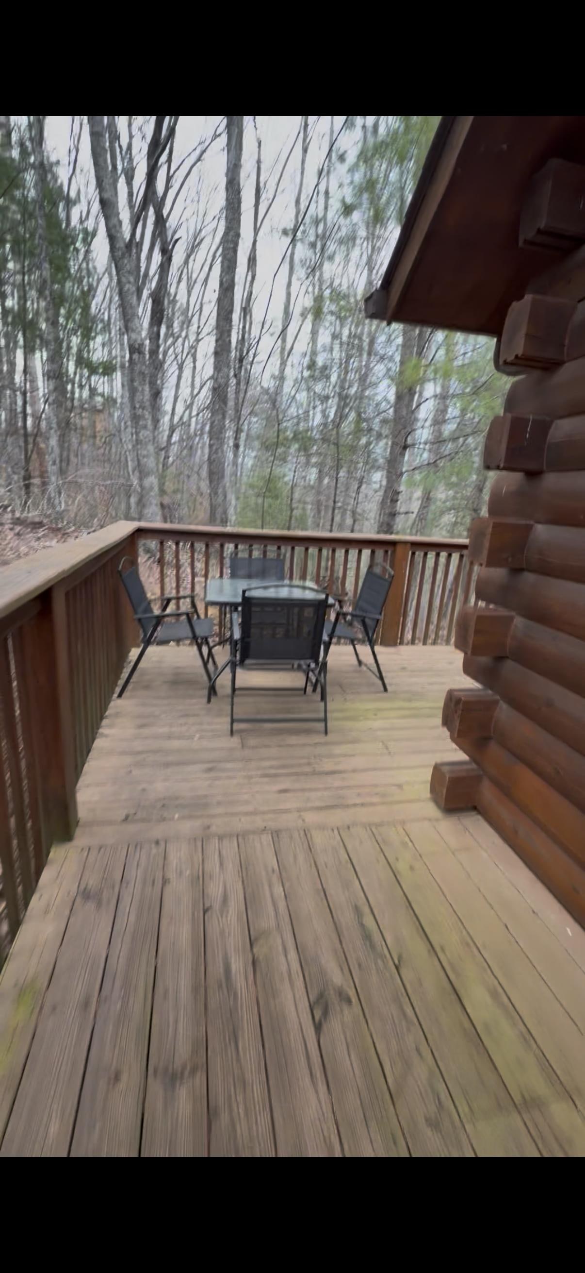 Table and chairs on back corner of deck 