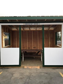 Smoking shack. Helps keep area clean of butts and gives smokers a place to go out of the heat, rain or snow. Very thoughtful