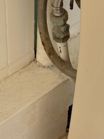 Dirt behind sink