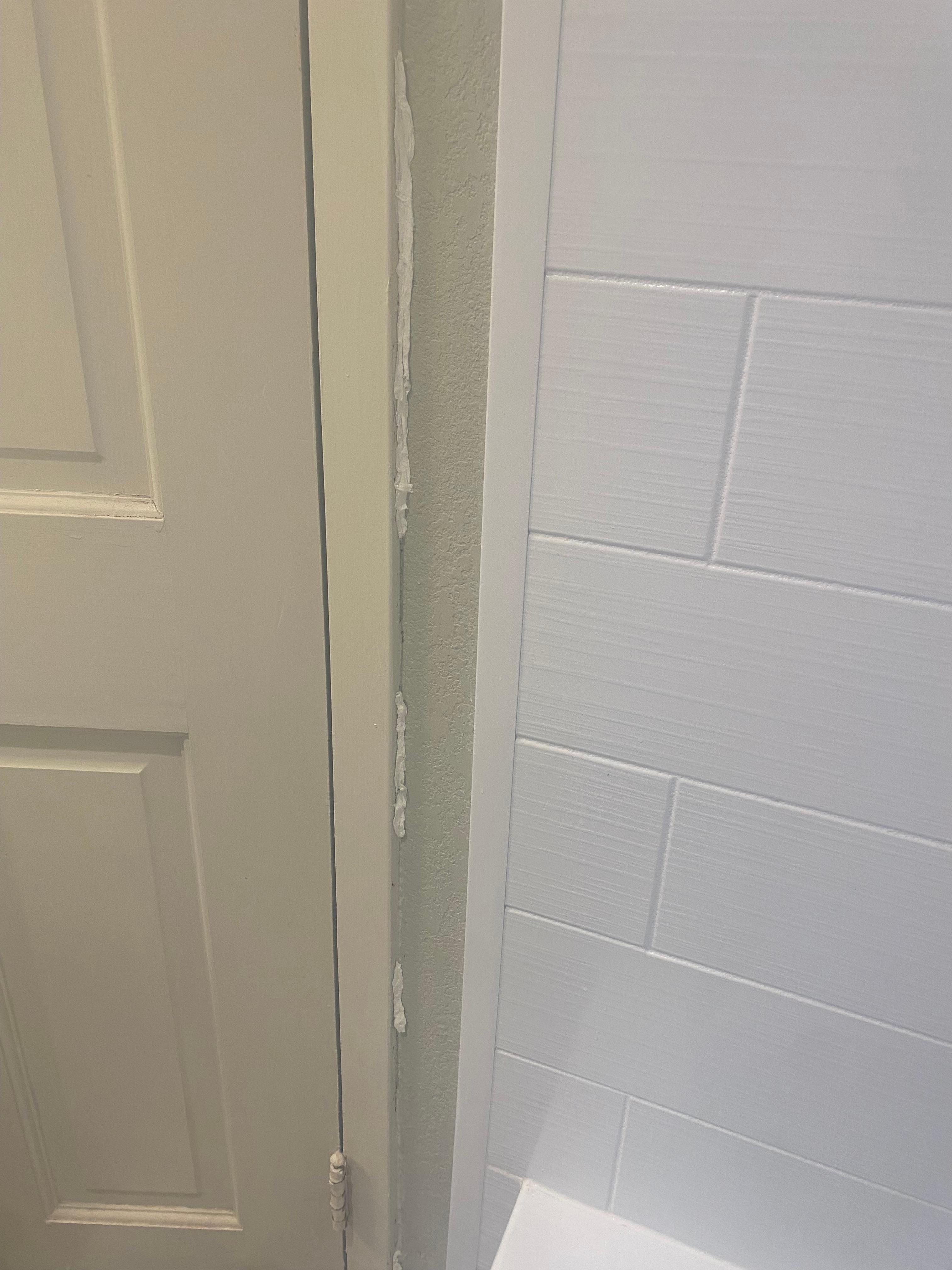 Tissue stuck in the cracks of the wall in the bathroom 