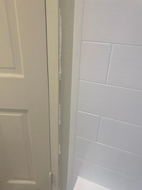 Tissue stuck in the cracks of the wall in the bathroom
