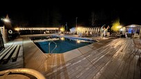 Pool area with hot tub at far right