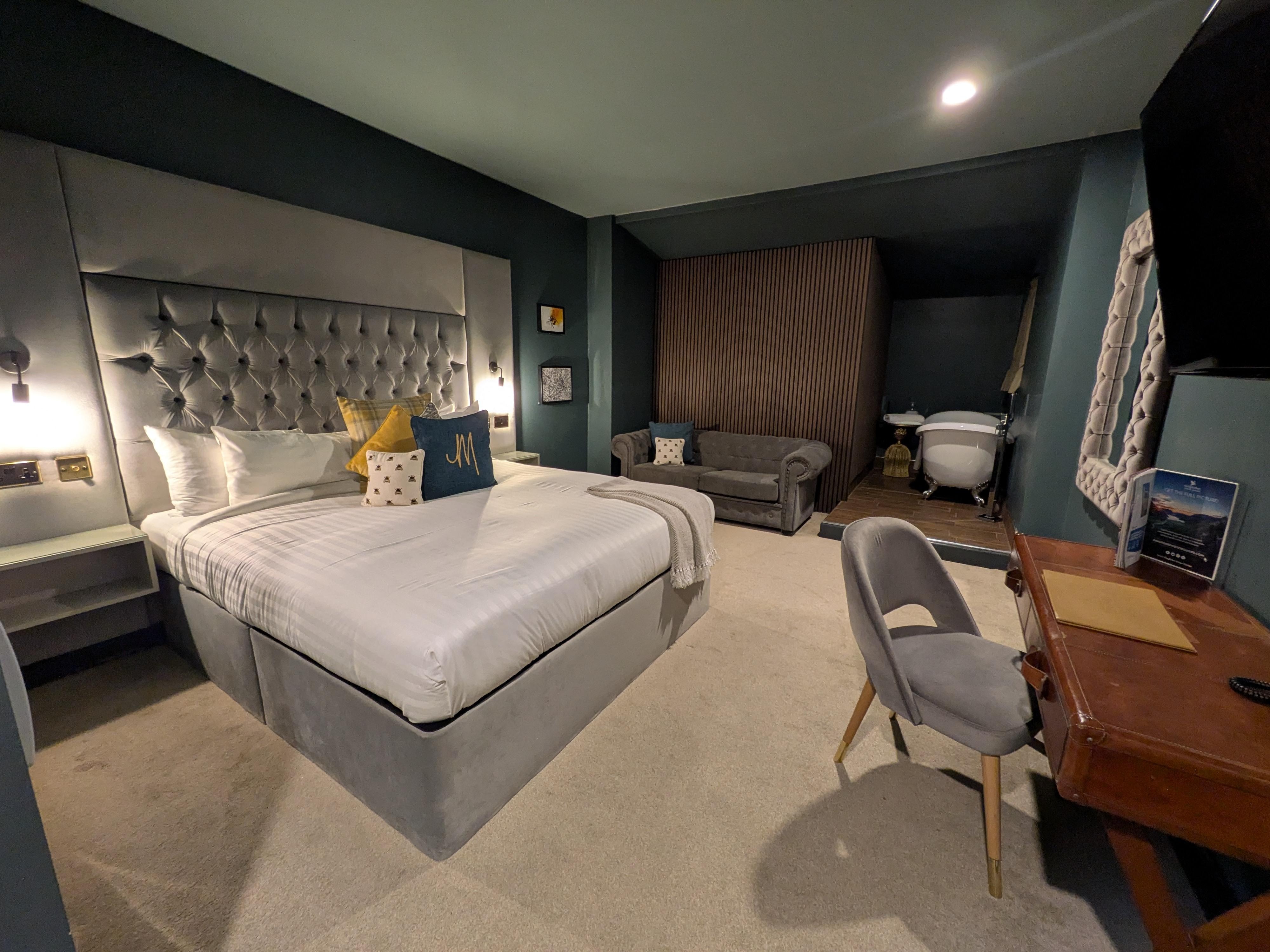 Large bedroom. Bed, lounge area, bath, desk