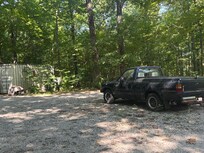 View from the porch. Junk truck parked in road.