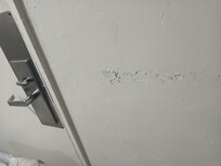 Paint peeling on wall inside room