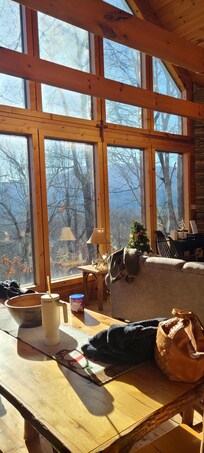 Beautiful 2 story windows frame the sunrise and a view of a starlit night.