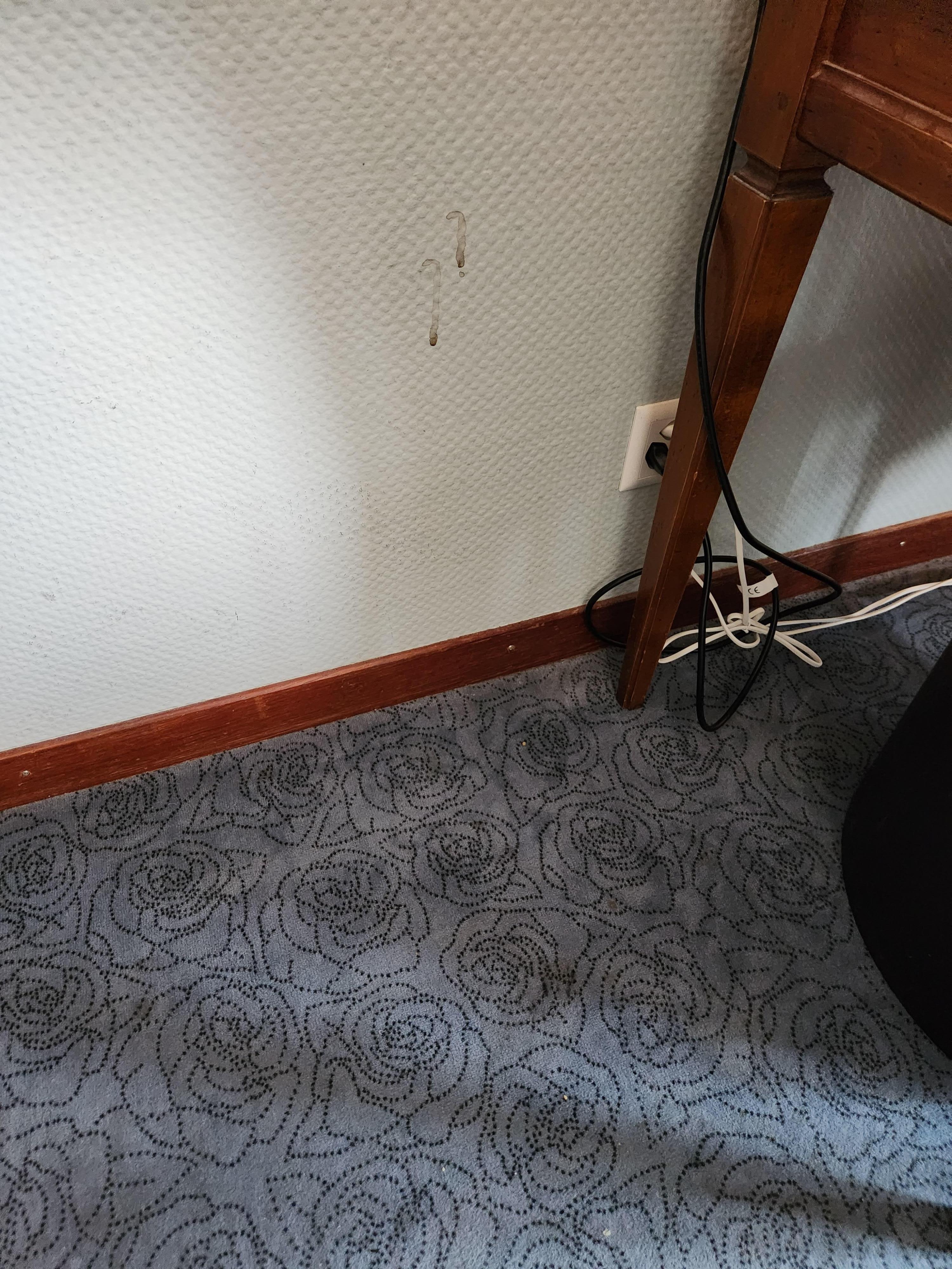 Thin felt on the floor. Stains on the wall