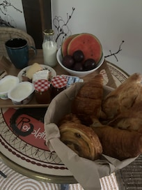 Fresh croissants, fruit, cheese, coffee, and local apple juice.
