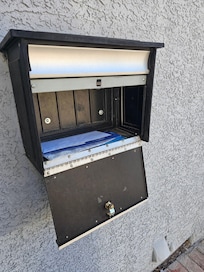 The mailbox has a lock on it but it had been broken open.