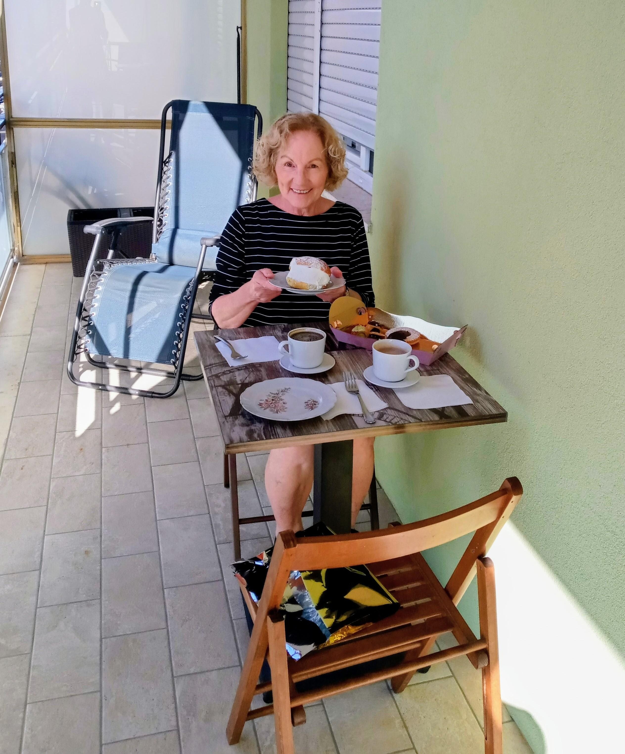 Enjoying coffee and pastry on the balcony.