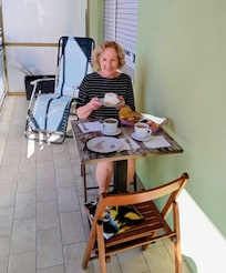 Enjoying coffee and pastry on the balcony.