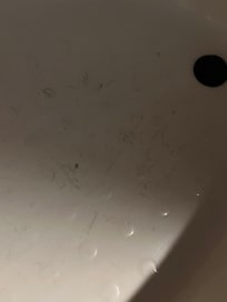 Dirty shower with lightbulb out above