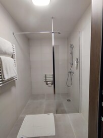 Standalone shower. Accessible set is too far from controls of the shower.