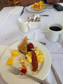 Delicious breakfast from eggs, potatoes, yummy pancakes, juice, good coffee