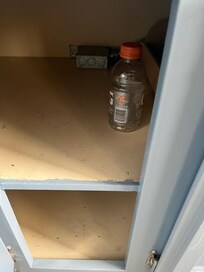 Empty Gatorade bottle in cabinet under stove
Additional photos to be provided