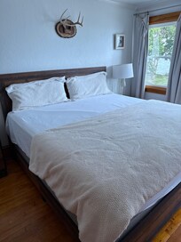 On of the bedrooms with a king bed, but only two pillows provided.