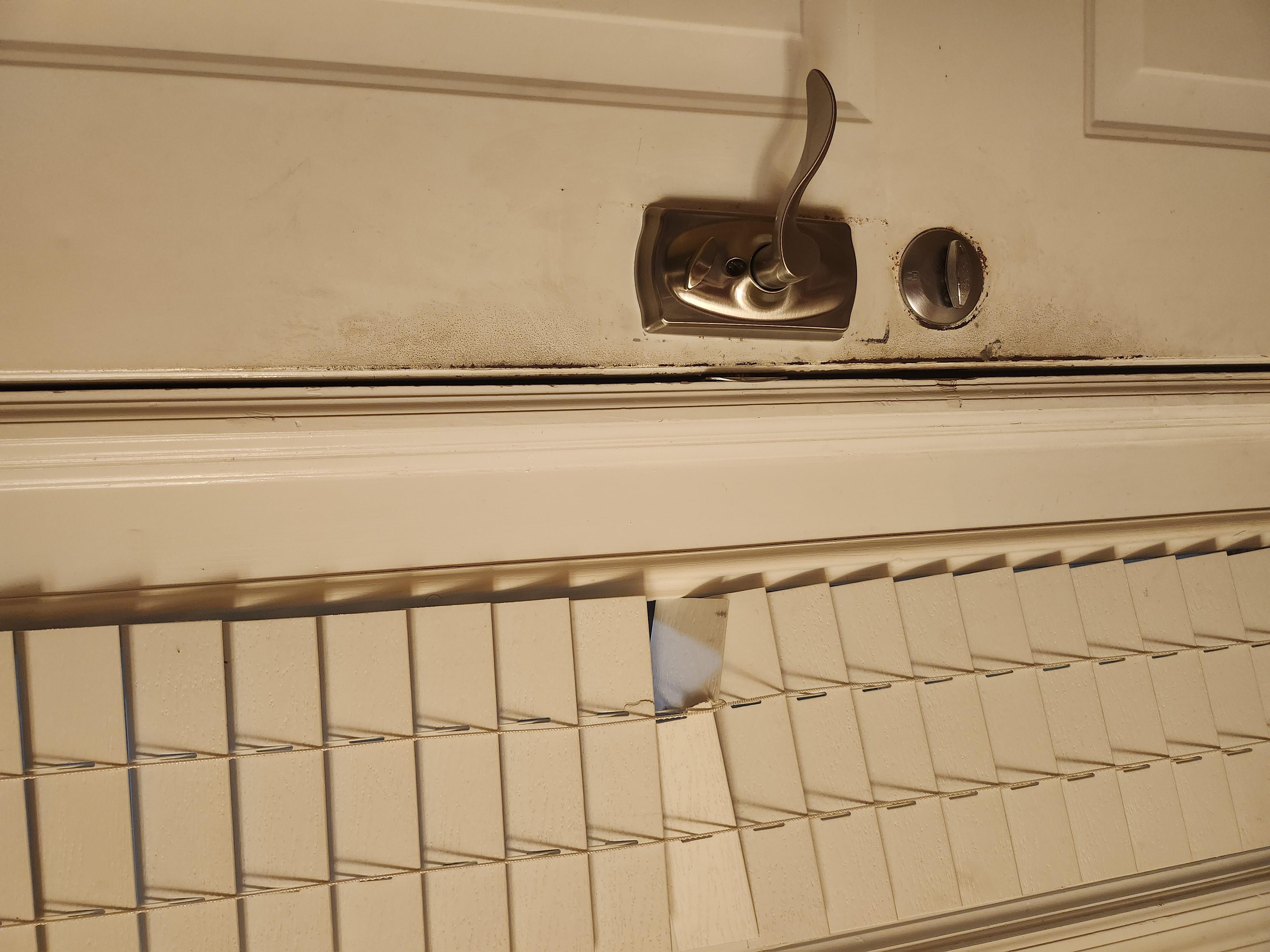 Front door dirty and broken shade.