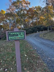 Loved this sign! It's looking up the road...the house is around that corner and on the right