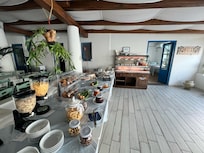 Breakfast includes croissants, biscuits, cakes, scrambled eggs, bacon, etc