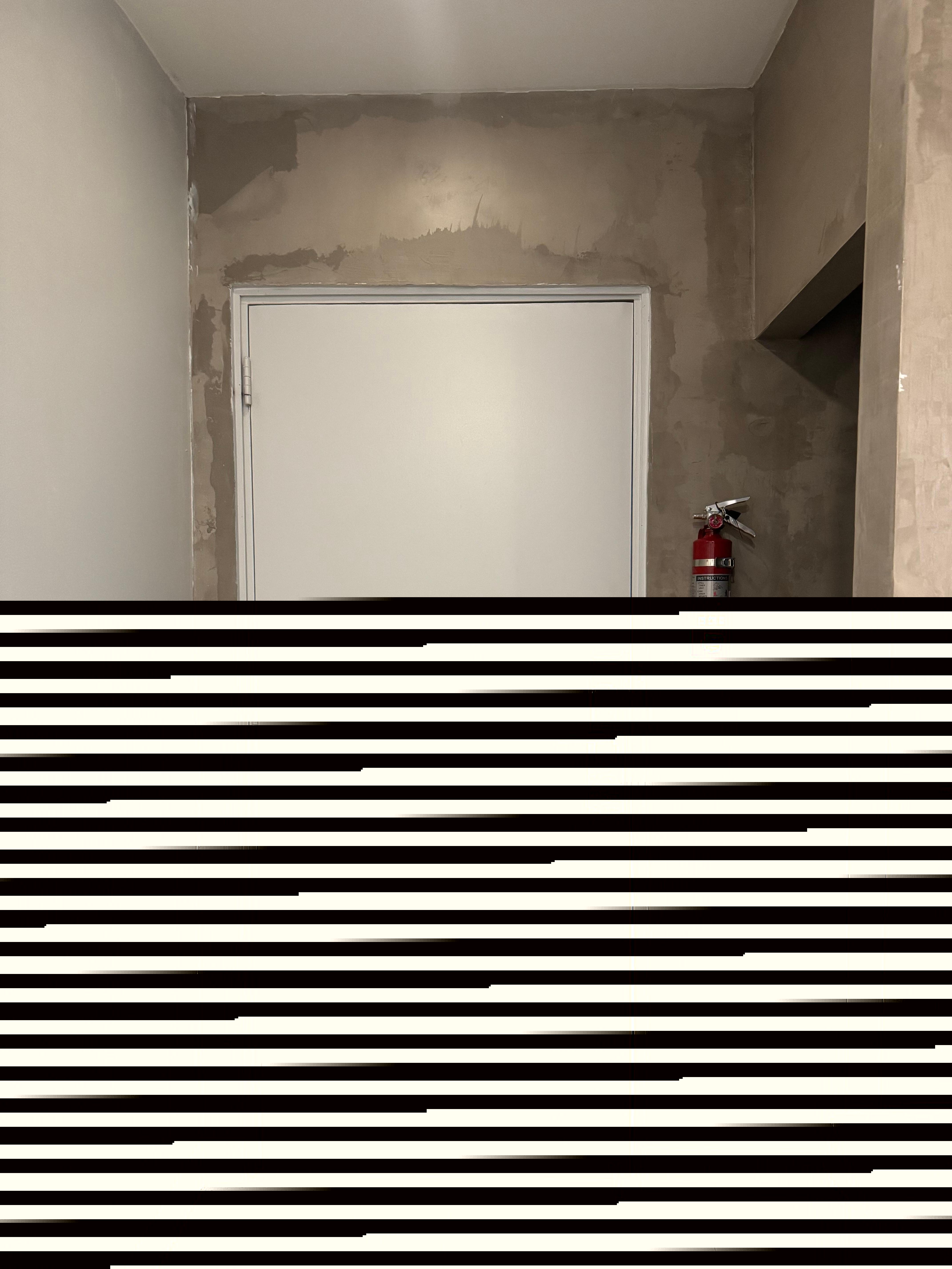 The door with chain guard, and the hole that leads to the bathroom 