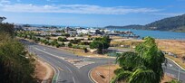 Busy noisy intersection . View towards Airlie and ocean.