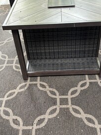 Side patio table and carpet with bird poop on it