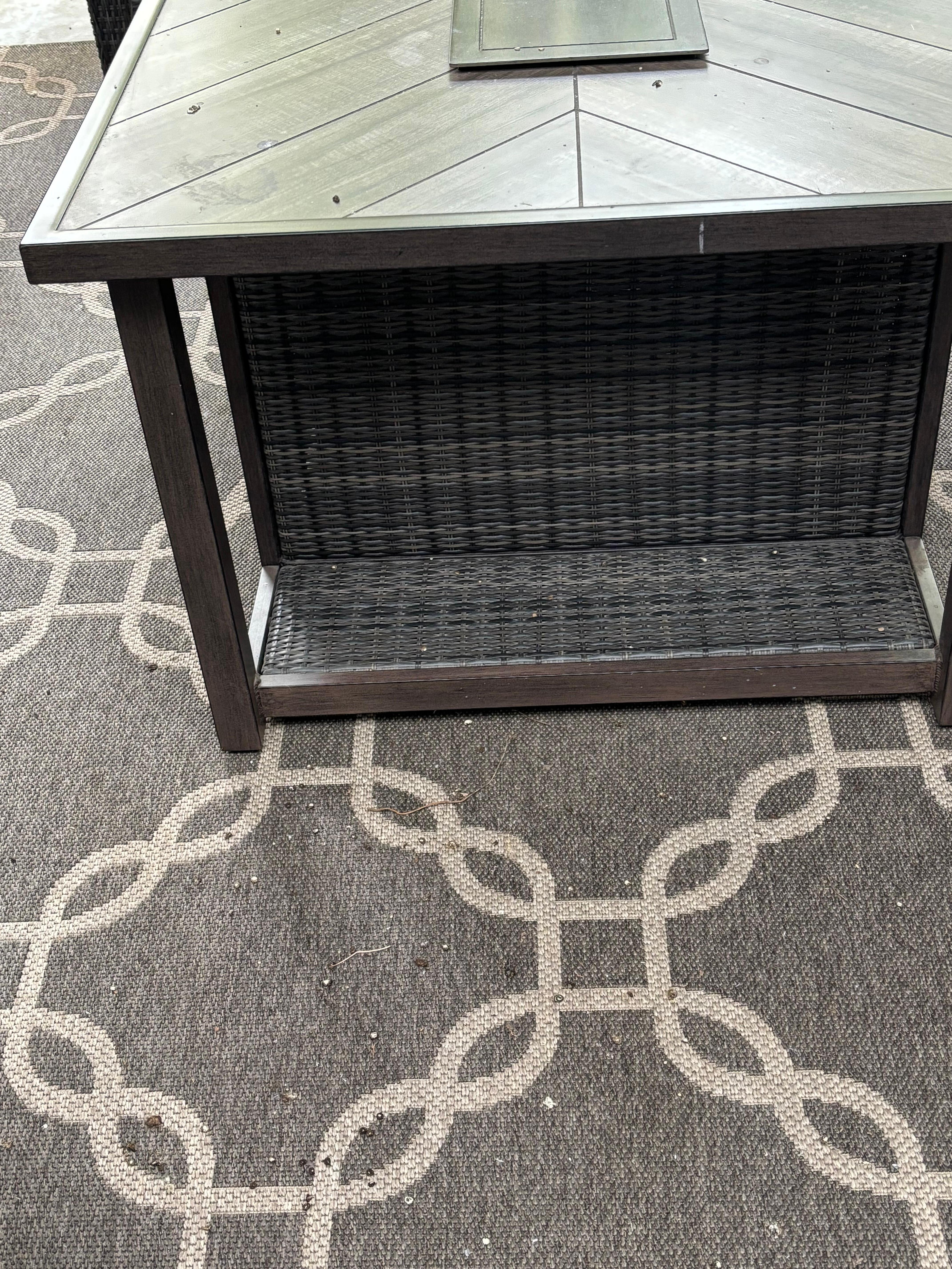 Side patio table and carpet with bird poop on it