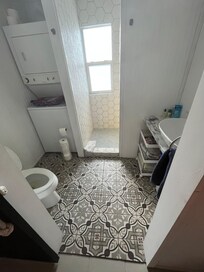 Bathroom complete with washer and dryer and great shower
