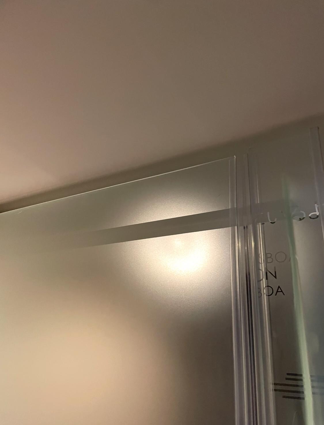 Glass partition for toilet open at the top, offering no privacy (not shown on hotel description)