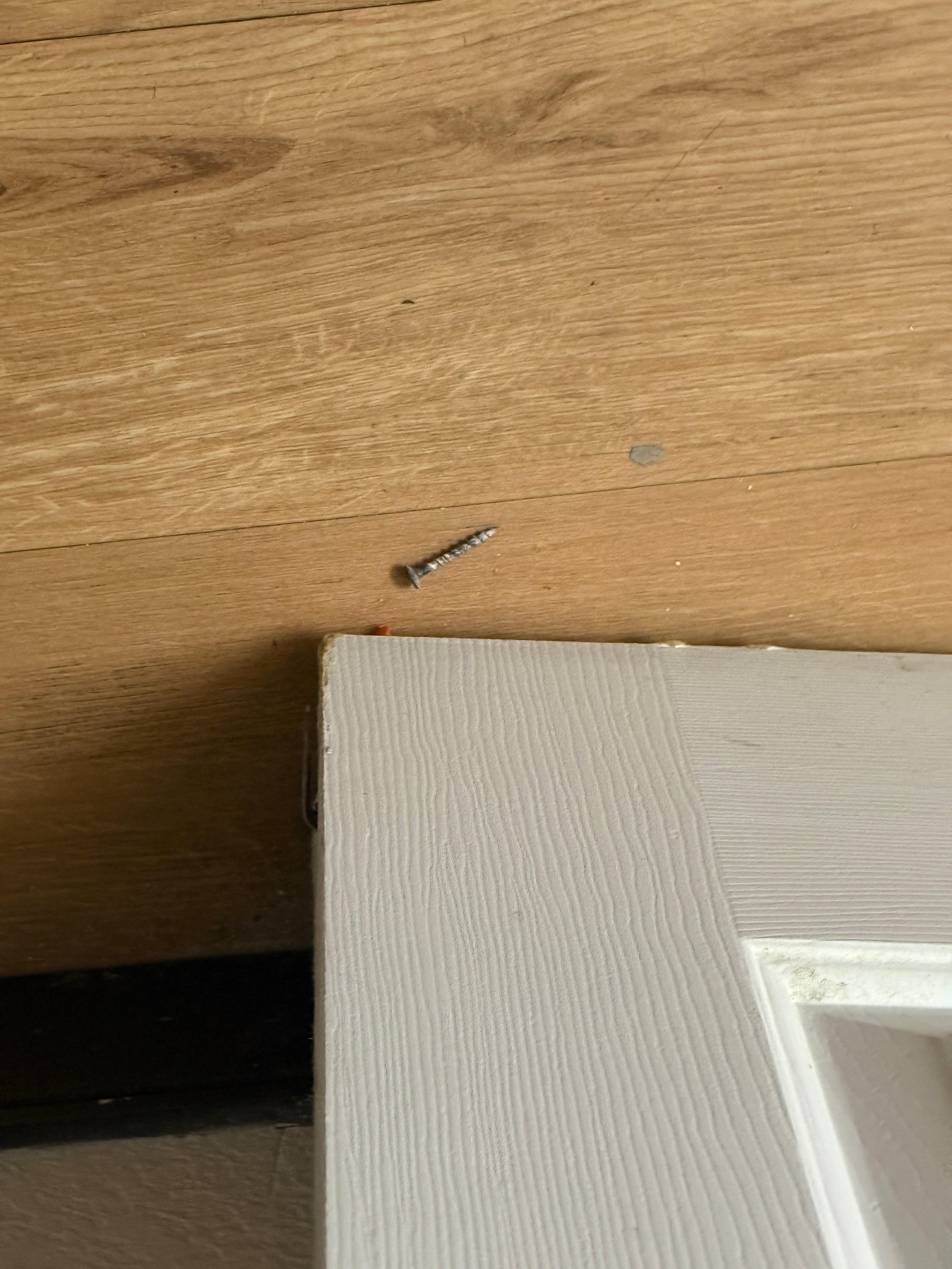 Screw laying on floor 