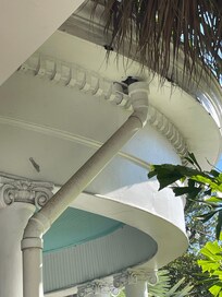 Balcony drainage pipes with visible holes.