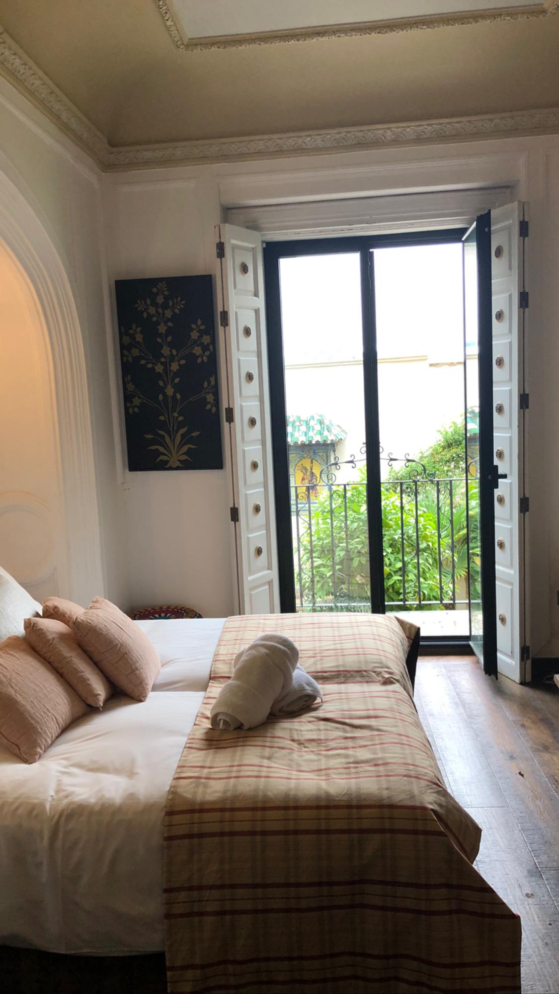 Bedroom looking out onto balcony and garden