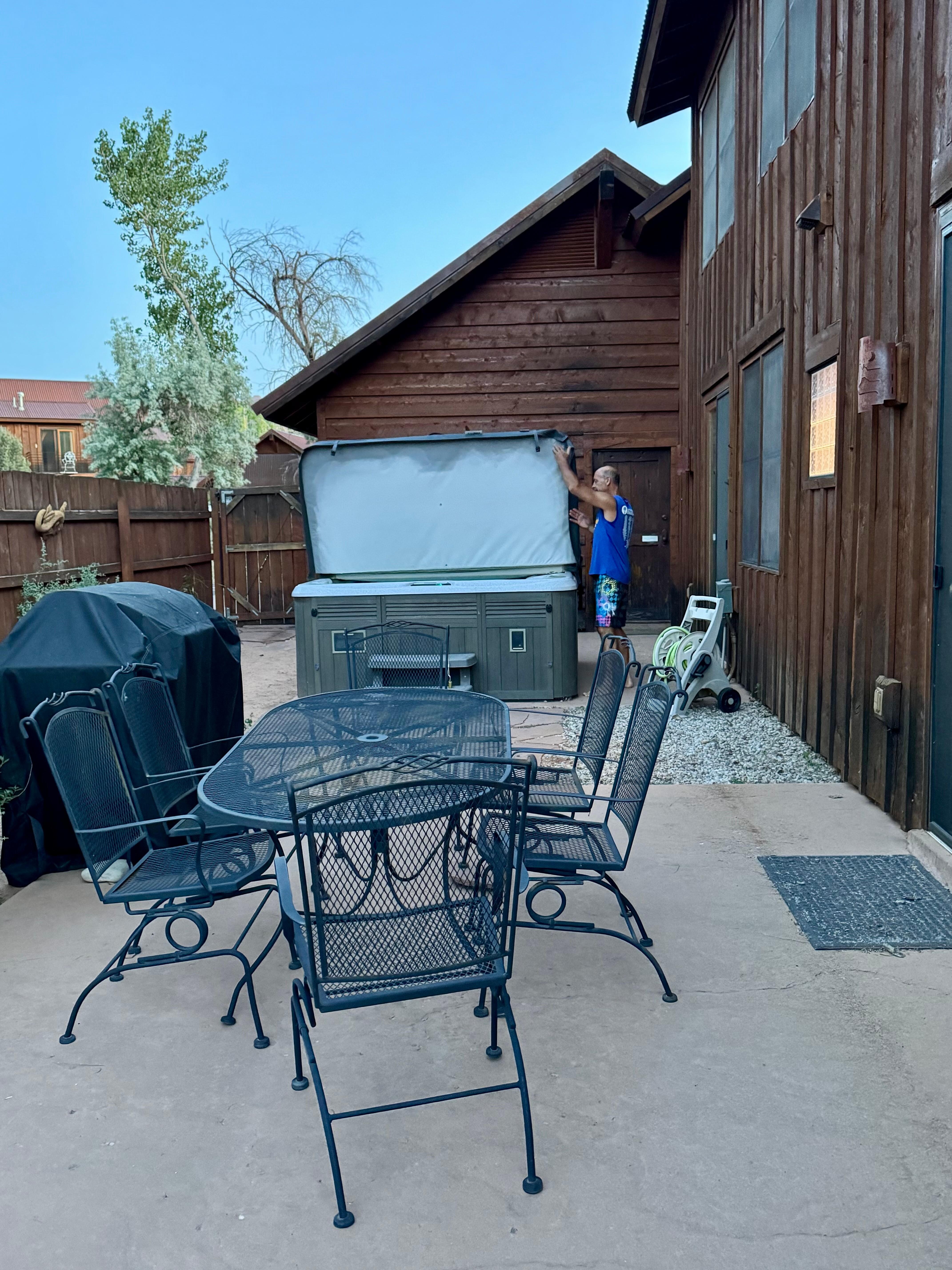 Side yard with hot tub, grill and dining area