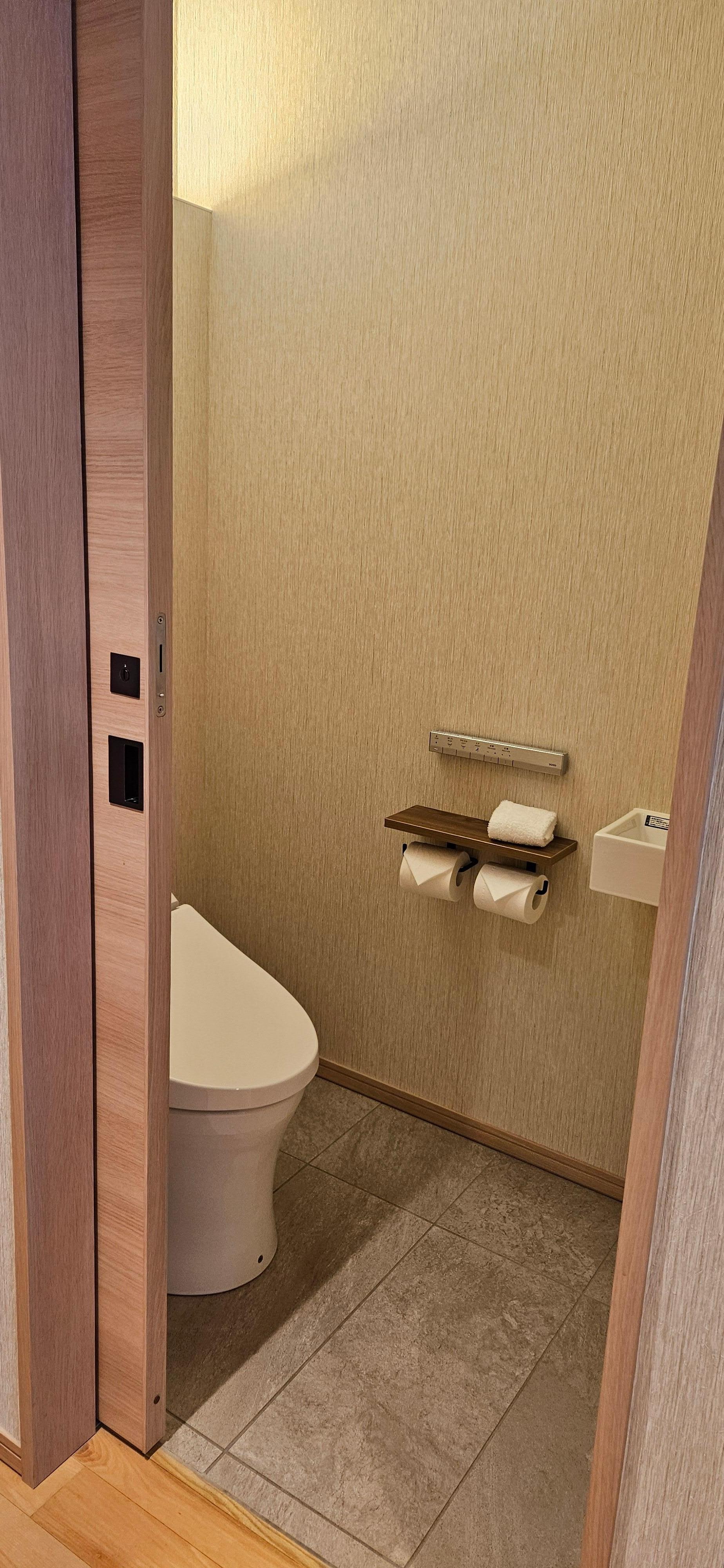 The room has a separate room for the toilet. 