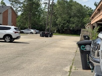 Garbage cans strewn in the parking lot.