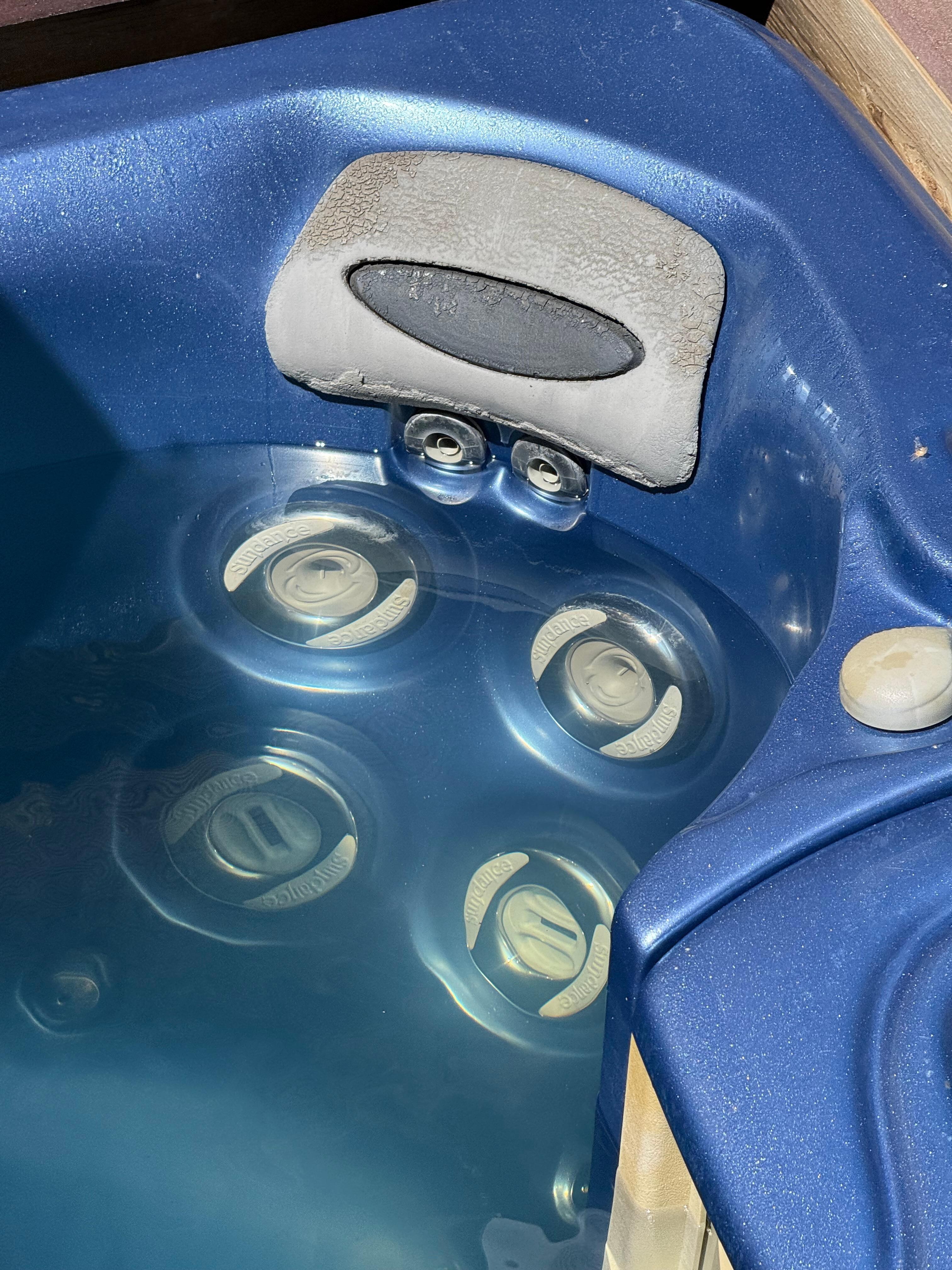 Murky hot tub and dirty head rest