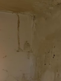 Large cobwebs under desk unit in full view.