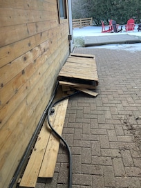 Electrical wire on ground We covered it with wood. Did not know if it was live.