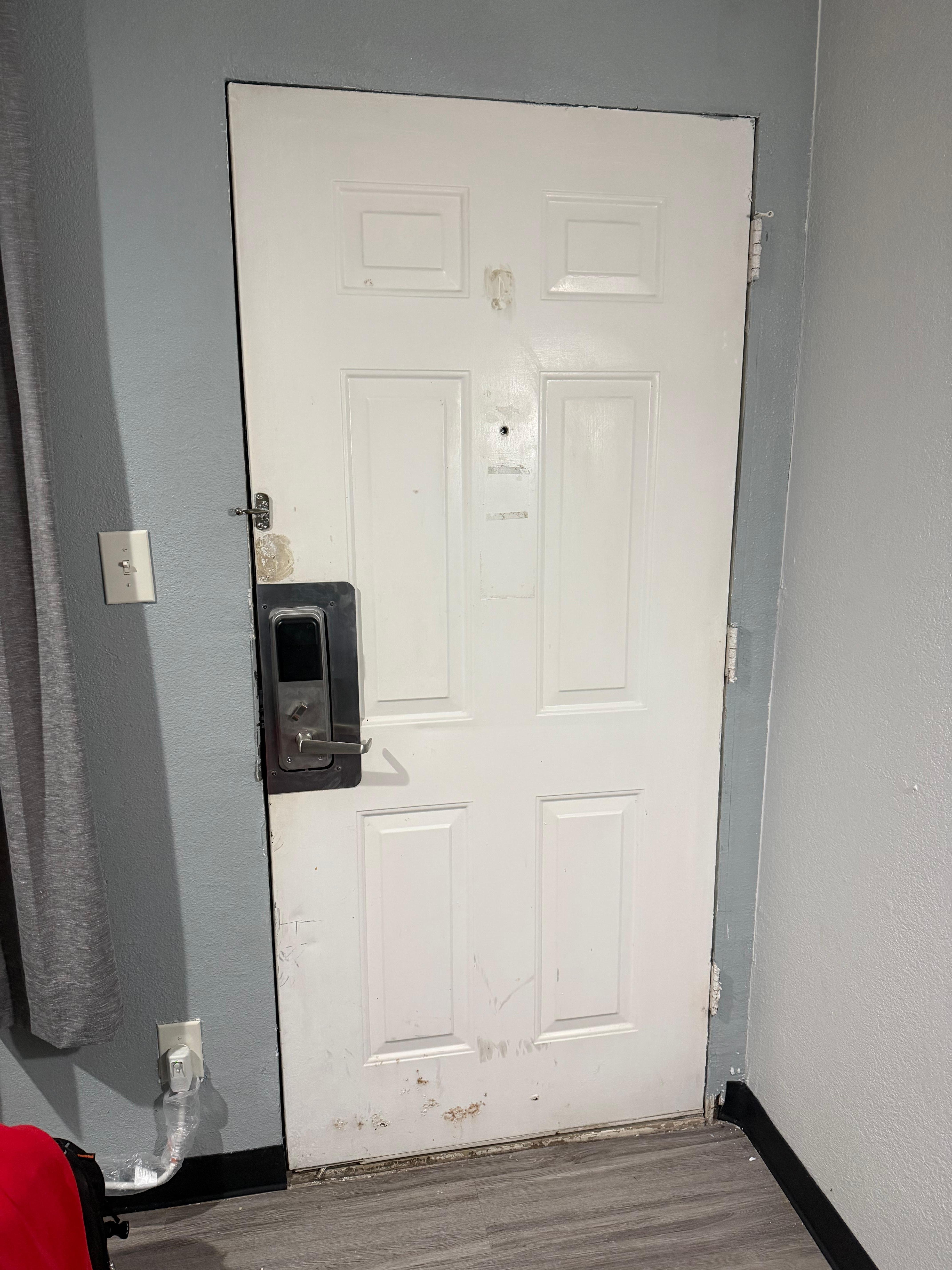 Missing trim. Missing a latch. Door is in need of repair. 